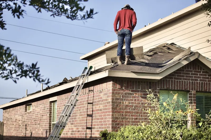 Professional roofer working on a residential roof in Rosedale